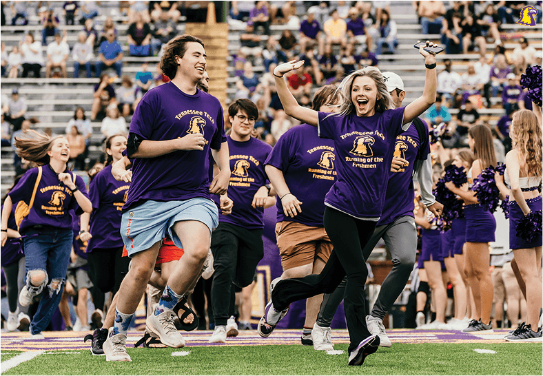 Students run on the field