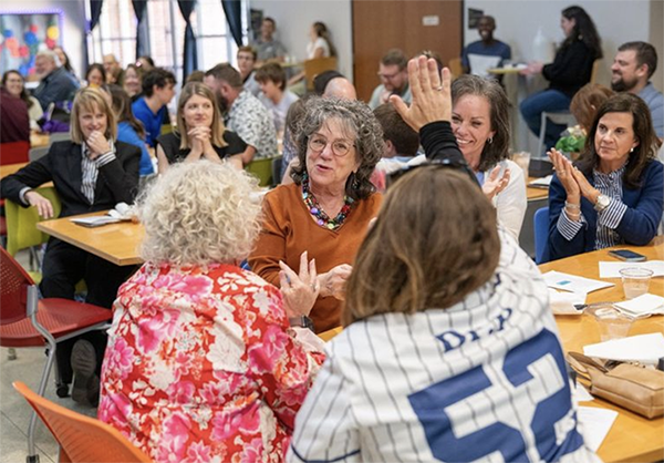 Happy students and educators celebrating during the awards reception.