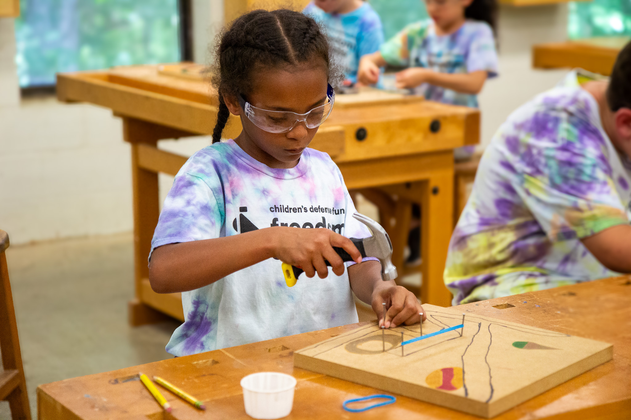 child operating a hammer safely
