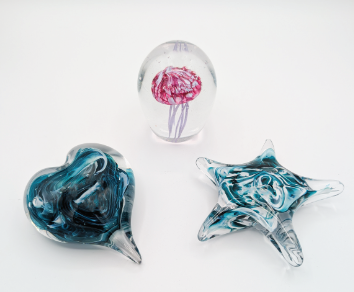 three glass paperweights