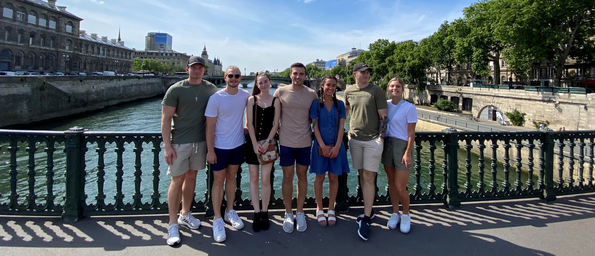 Group of students on bridge over river
