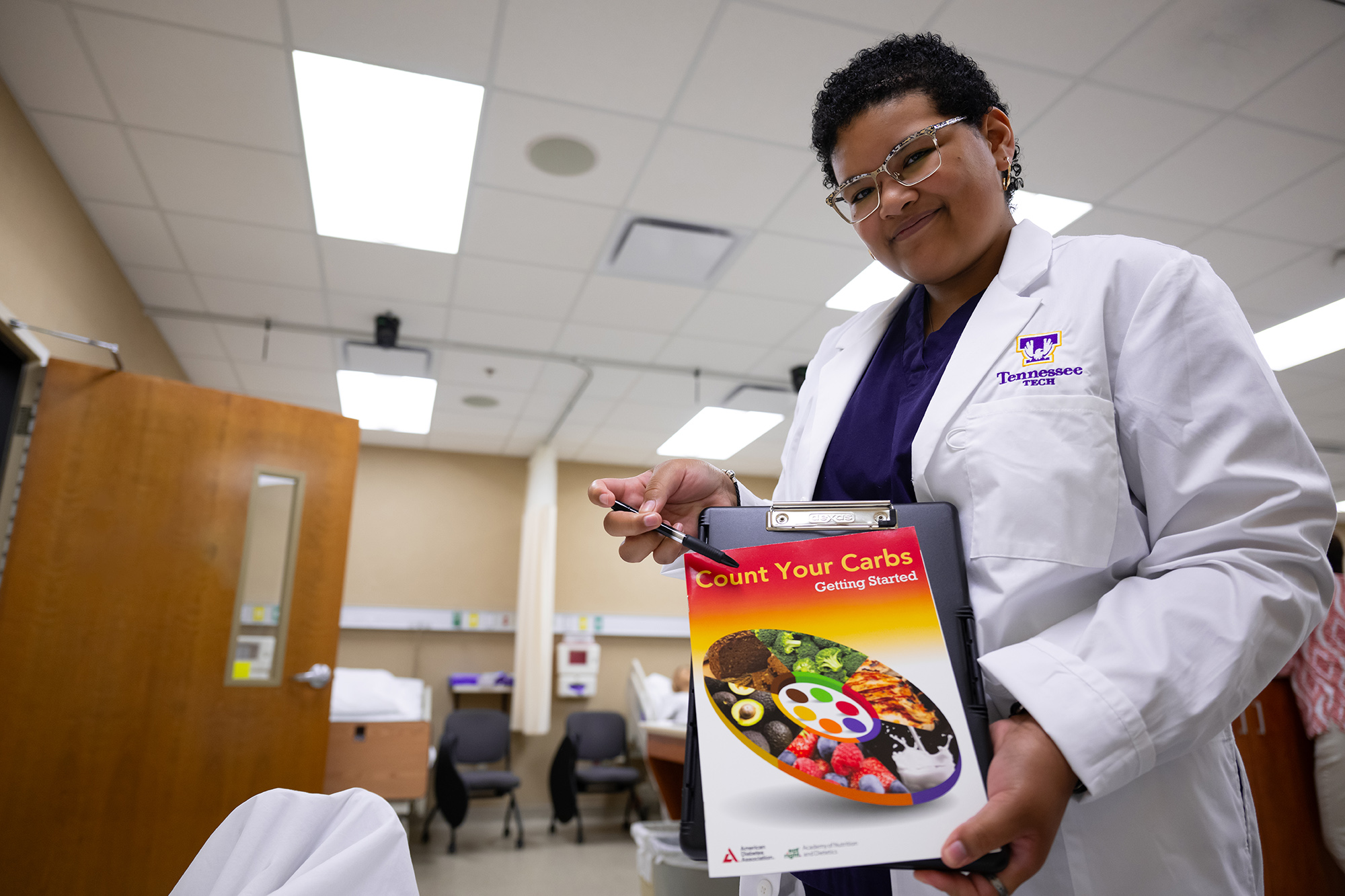 a healthcare working displaying information pamphlets to a patient