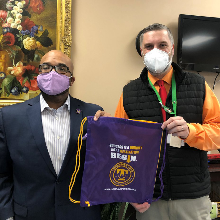 Harry Ingle and Thomas Fuhrman  holding a College of Engineering drawstring backpack