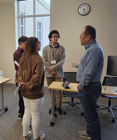 Retreat attendees talking with faculty