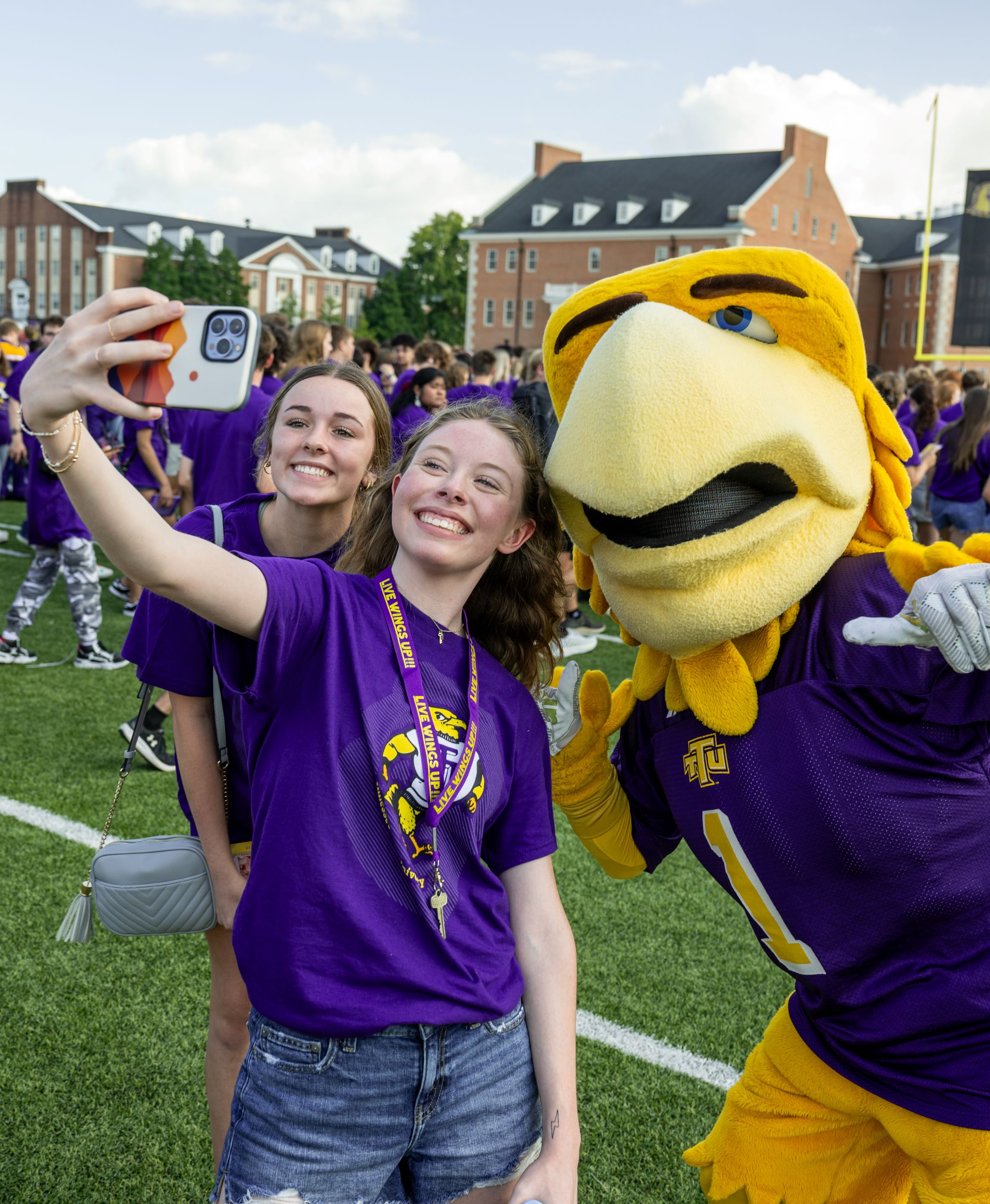 Students taking a photo with Awesome Eagle
