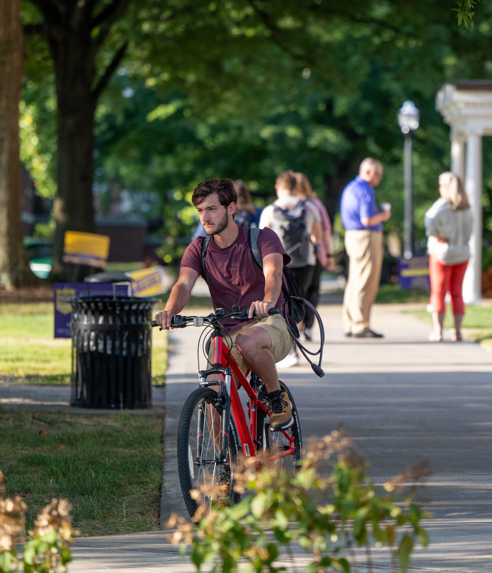 Transfer student biking on campus