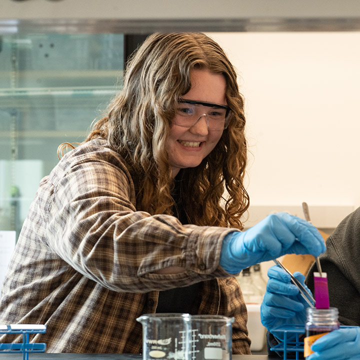 A student in a lab using Chemistry equipment.