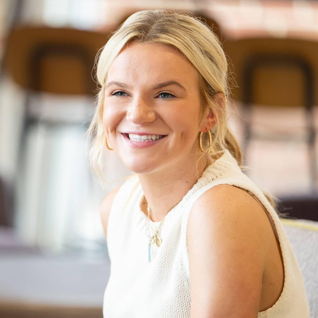 Student smiling in a white shirt