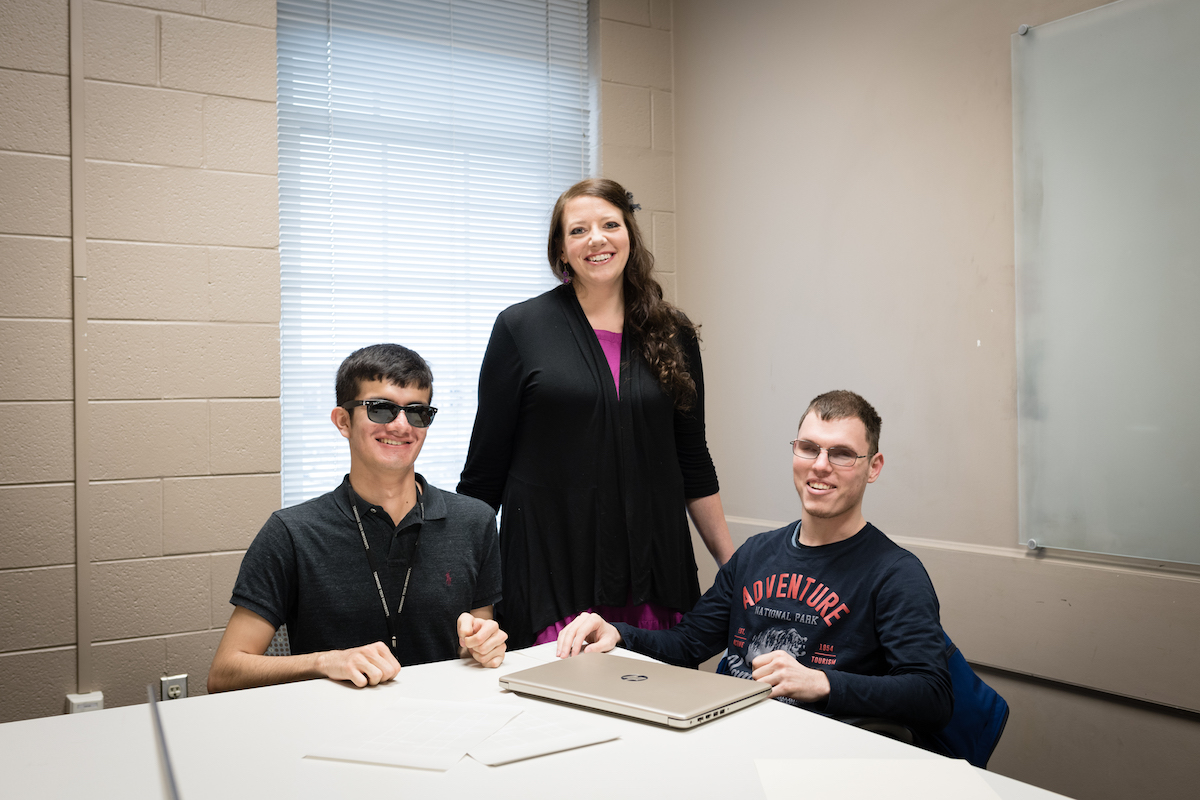 Computer science instructor April Crockett helps students Vadim Kholodilo and Carlos Medrano with tactile diagrams printed in braille.