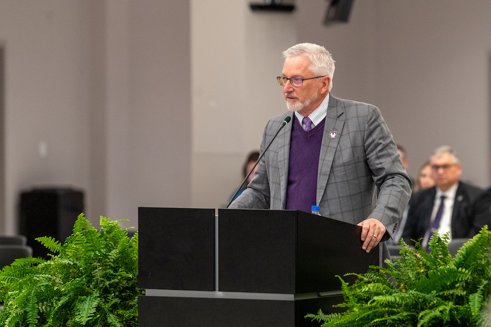 President Phil Oldham presents his report at the December 2022 Board of Trustees meeting.