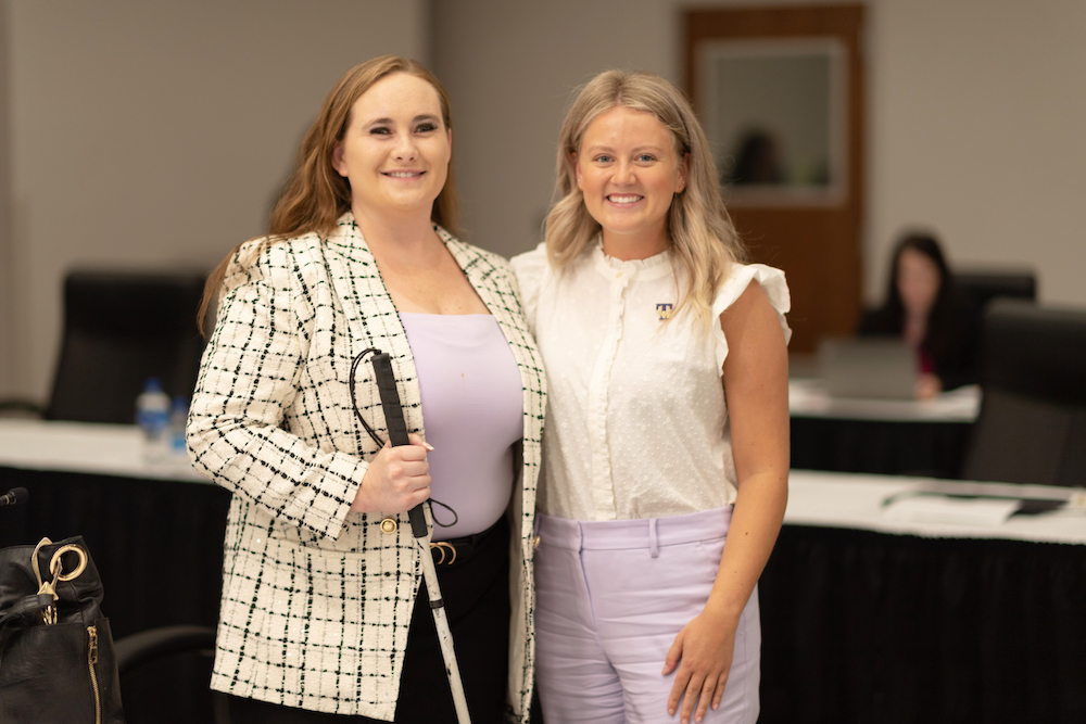 Hannah Willis (pictured at left) congratulates newly selected student trustee Savannah Griffin (pictured at right).