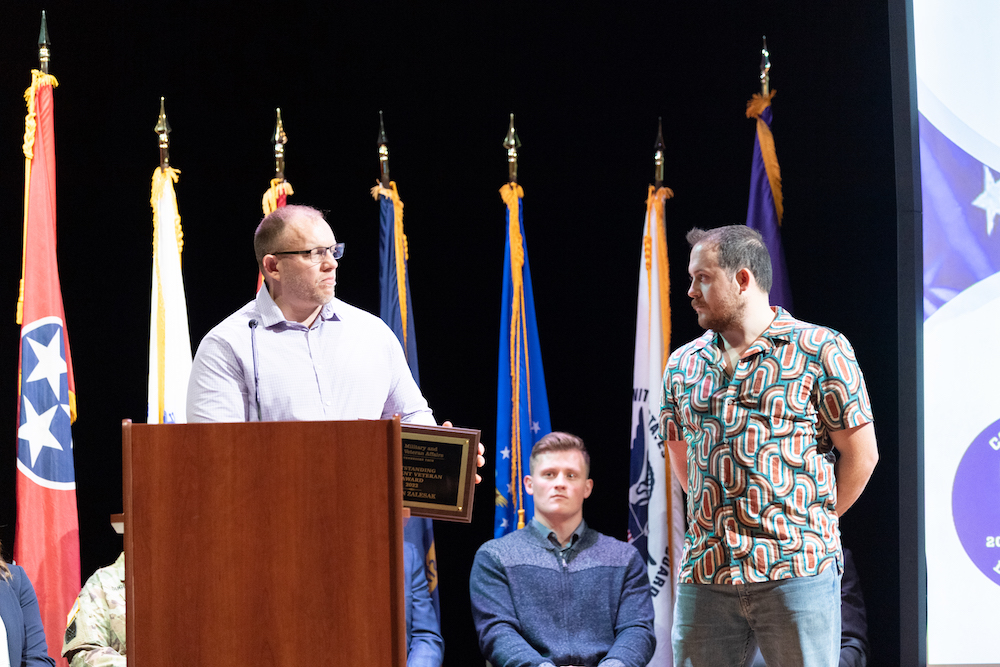 Luke Notman, assistant director of military and veterans affairs, presents Kevin Zalesak with the Outstanding Student Veteran Award.