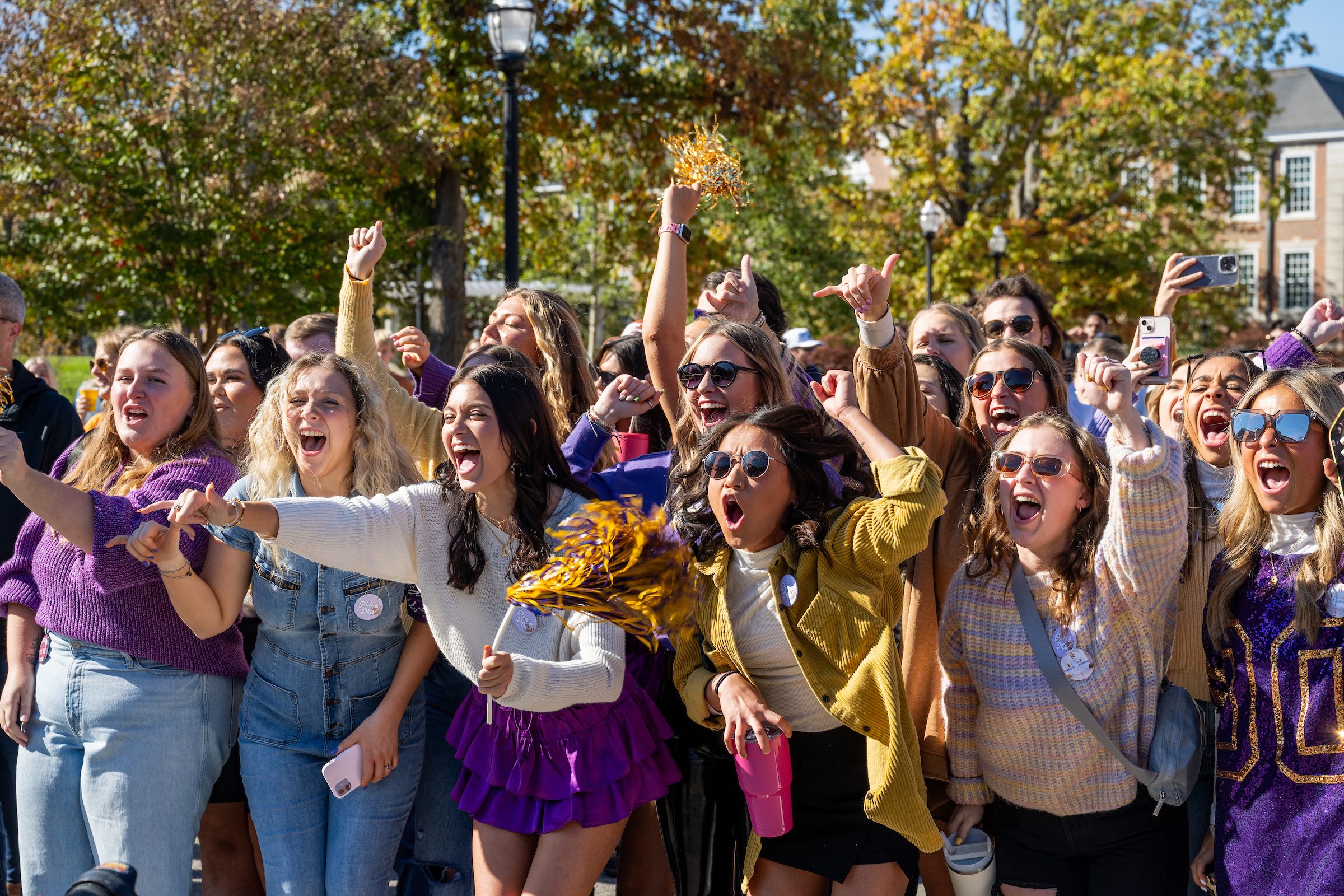 Golden Eagles wear their purple and gold to cheer on classmates at Tech's 2023 homecoming parade.