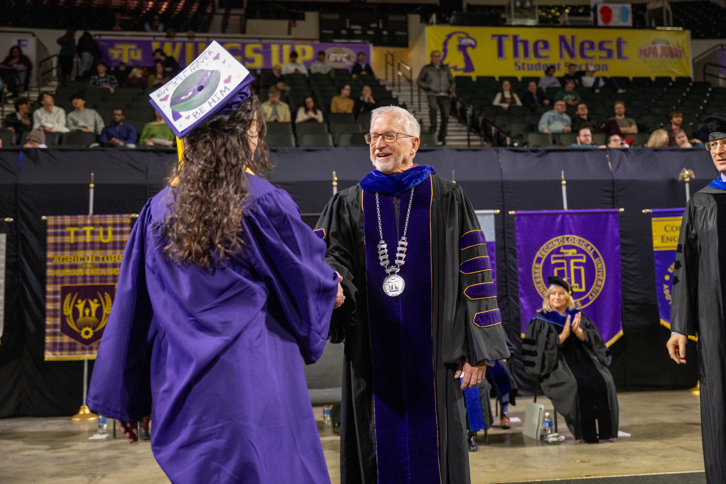 Tech President Phil Oldham congratulates a graduate during Tech's morning commencement ceremony.