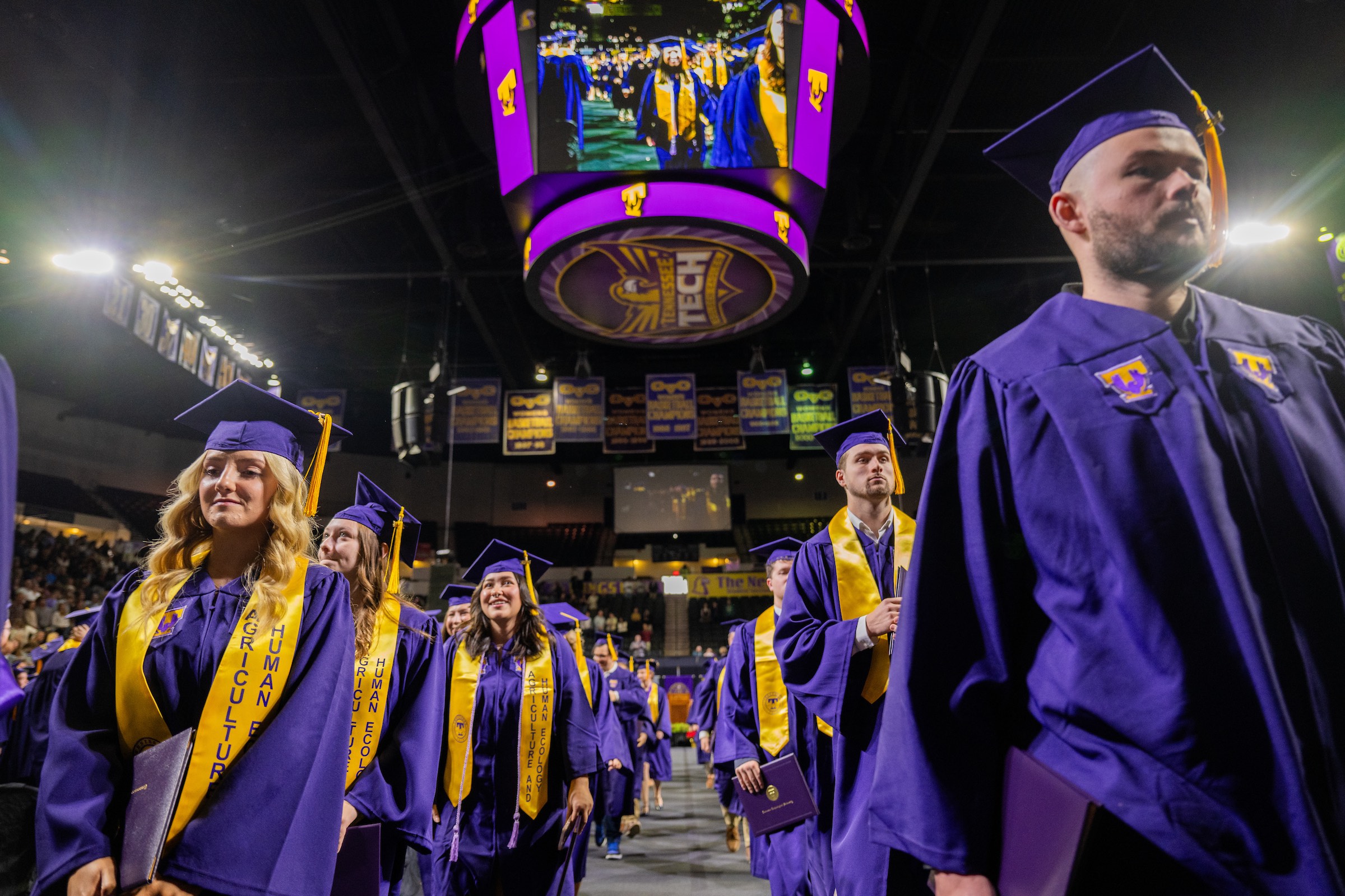 Graduates line up to receive their degrees. 