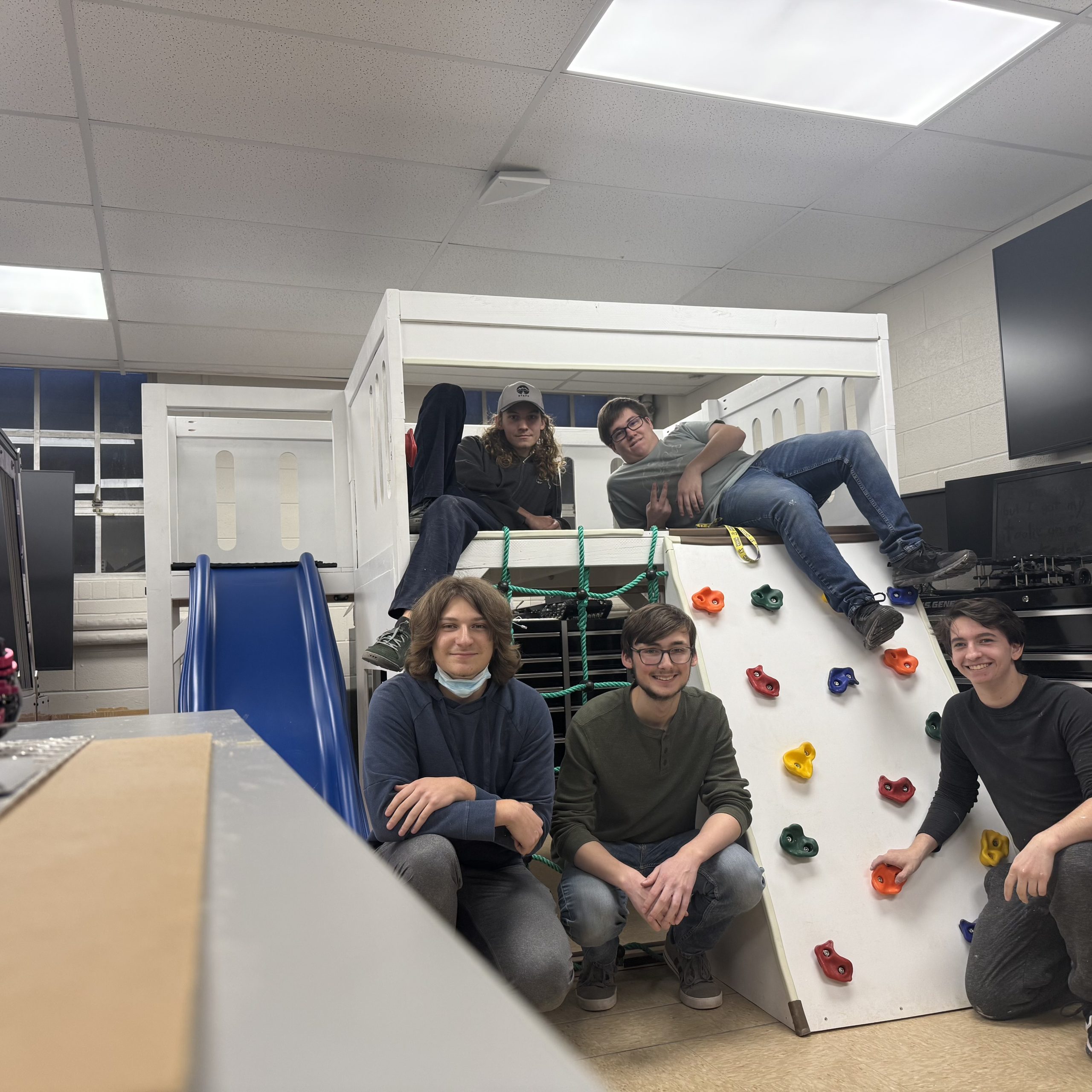 Some of the Tech Engineering for Kids team members take a moment to enjoy their effort of designing, building and painting a climbing play set before delivering it to a Wilson County child with autism. The students on the bottom, from left, are Frederick Heerdt, Sean Borchers and Joshua Matson, while on top of the platform, from left, Aiden Bull and Carter Birdwell survey their results.