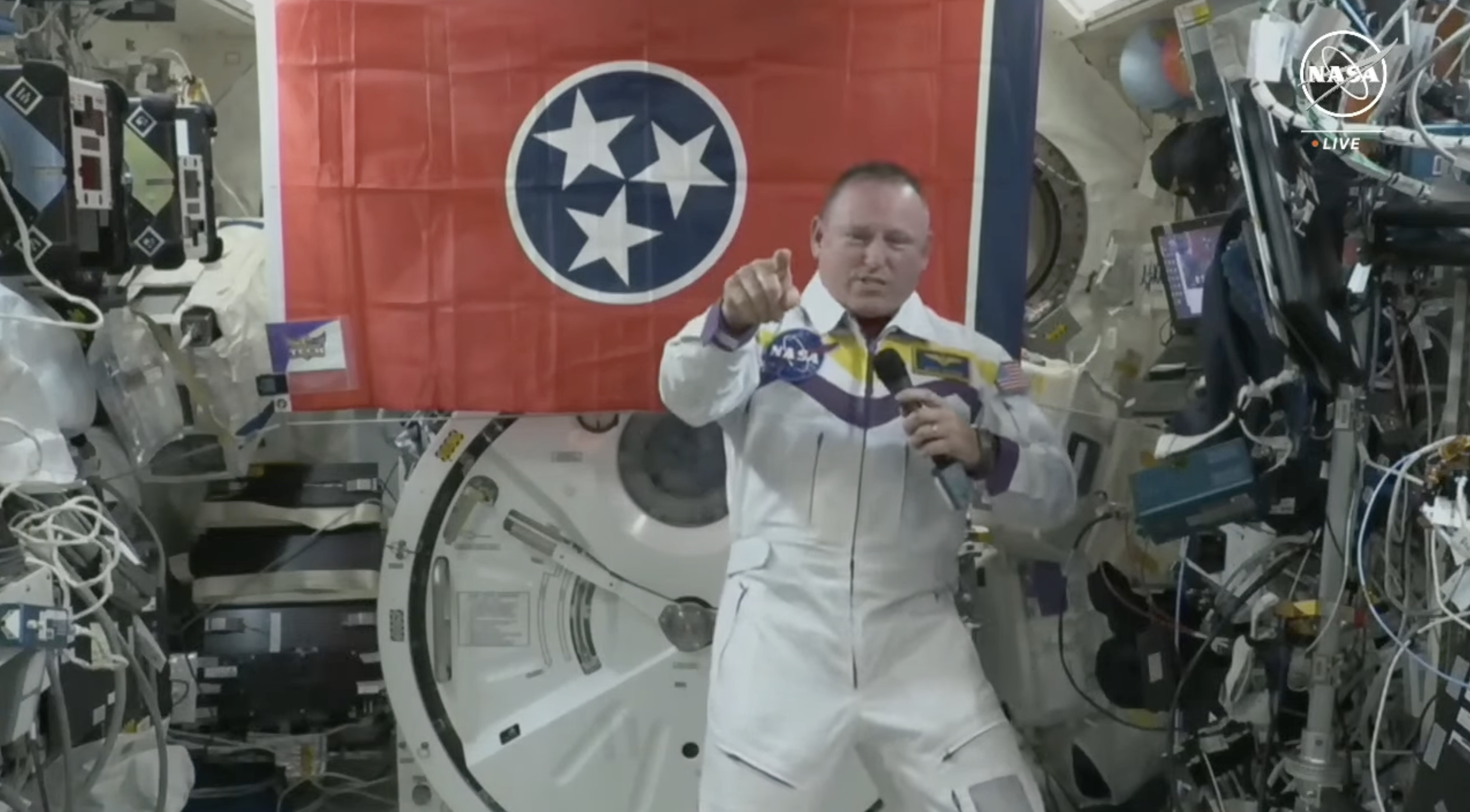 Tennessee Tech alumnus and trustee Barry “Butch” Wilmore appears in Tech’s signature purple and gold colors to speak with local students in a video chat from the International Space Station on June 11, 2024. A Tennessee Tech athletics decal is seen at left. Photo: Screengrab of live event via NASA TV. 