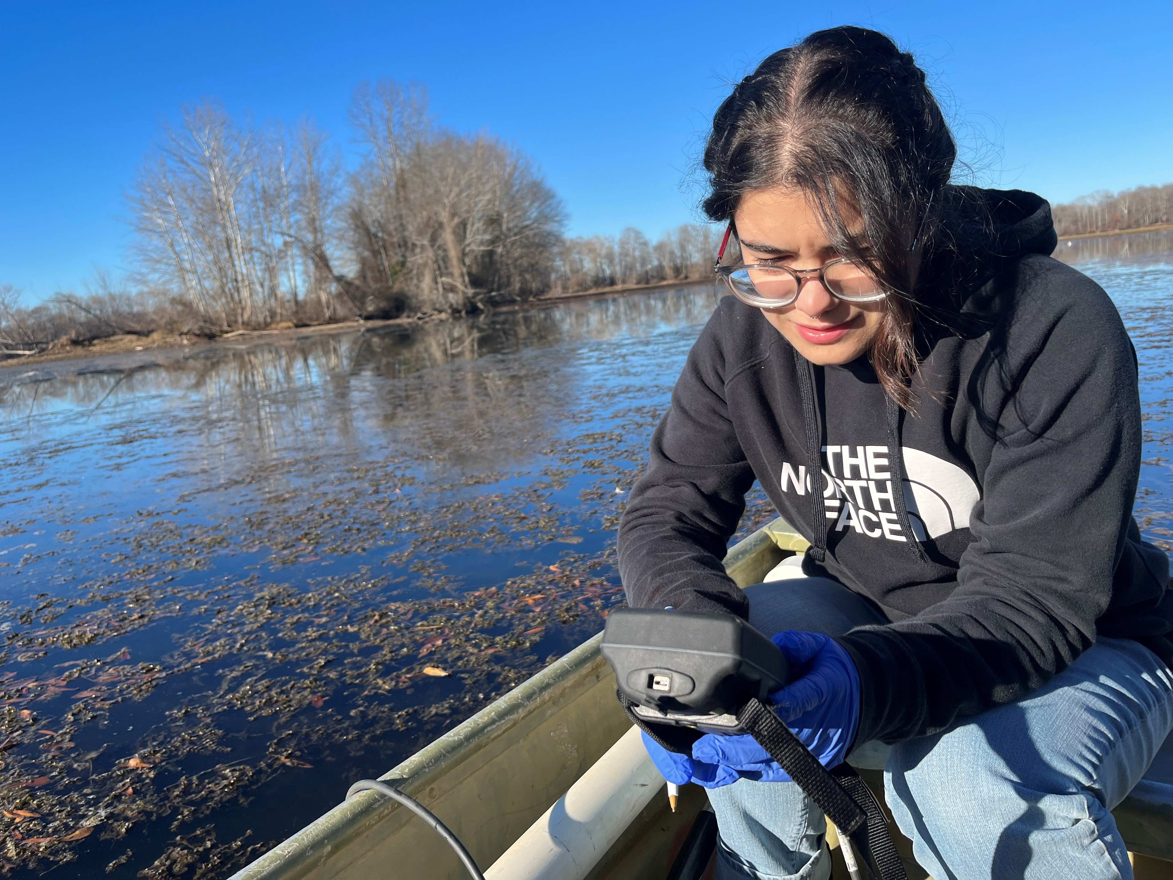 Gabi De Almeida, a master's student in civil and environmental engineering, collects water quality data in Woods Reservoir, Tenn. 