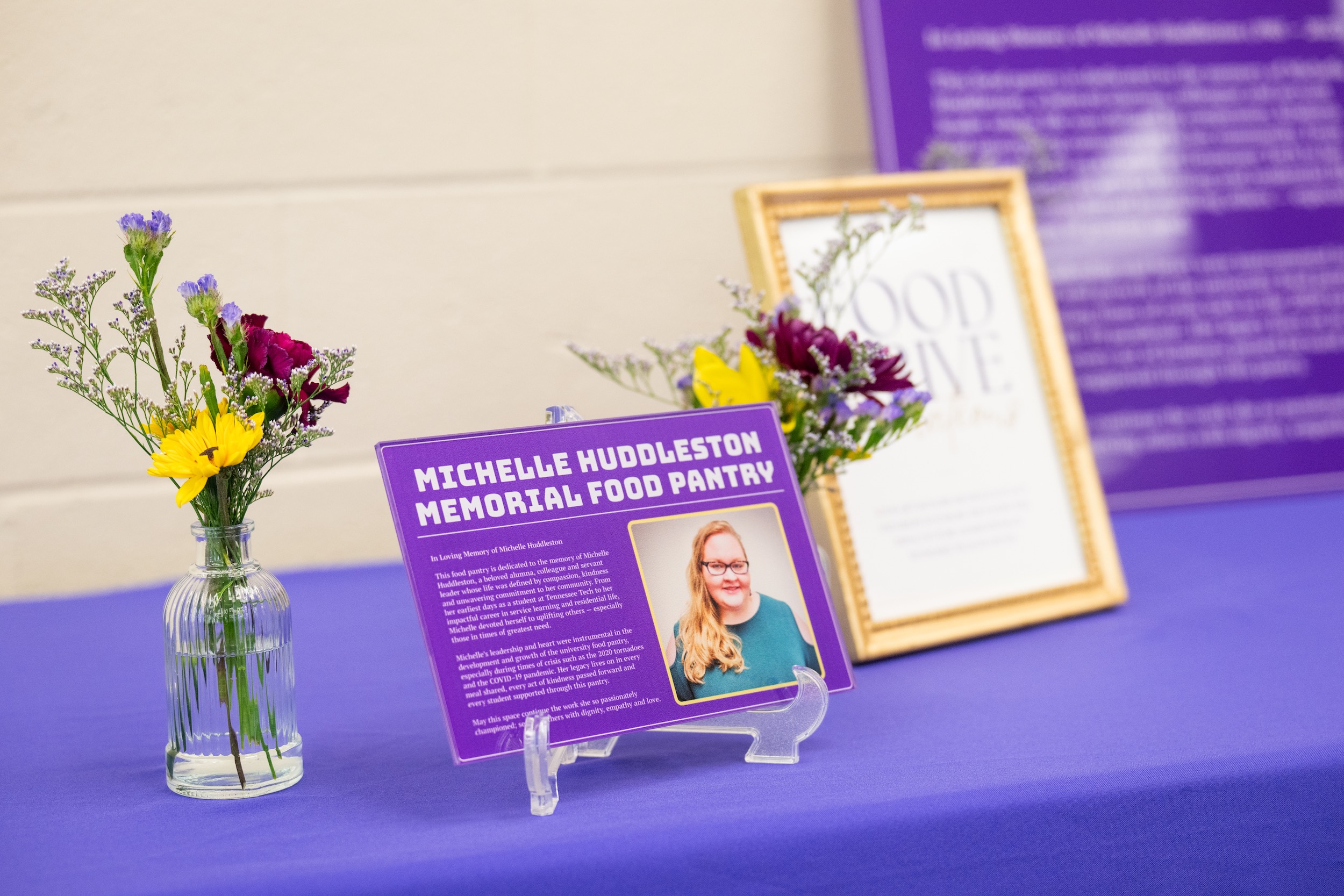 A placard for the Michelle Huddleston Memorial Food Pantry is displayed at the pantry’s April 15 dedication ceremony. Huddleston was a two-time Tennessee Tech graduate and longtime staff member who helped establish the pantry in 2012 and was instrumental in its continued operation. She passed away in October 2023. A placard for the Michelle Huddleston Memorial Food Pantry is displayed at the pantry’s April 15 dedication ceremony. Huddleston was a two-time Tennessee Tech graduate and longtime staff member who helped establish the pantry in 2012 and was instrumental in its continued operation. She passed away in October 2023.