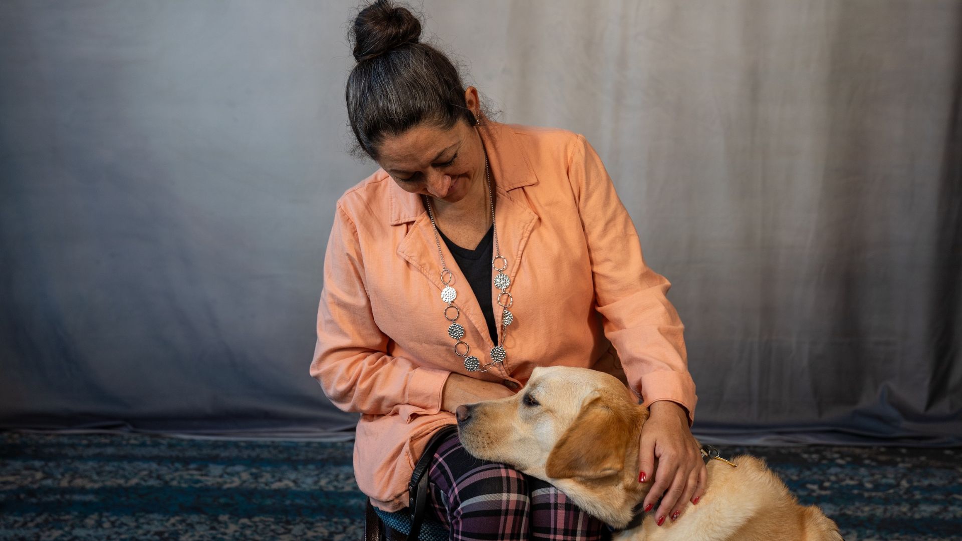 Amanda Juetten Amanda Juetten is seated smiling with her guide dog, Colonel