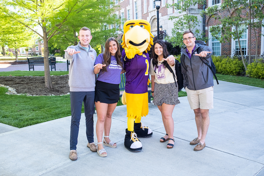 students showing wings up sign