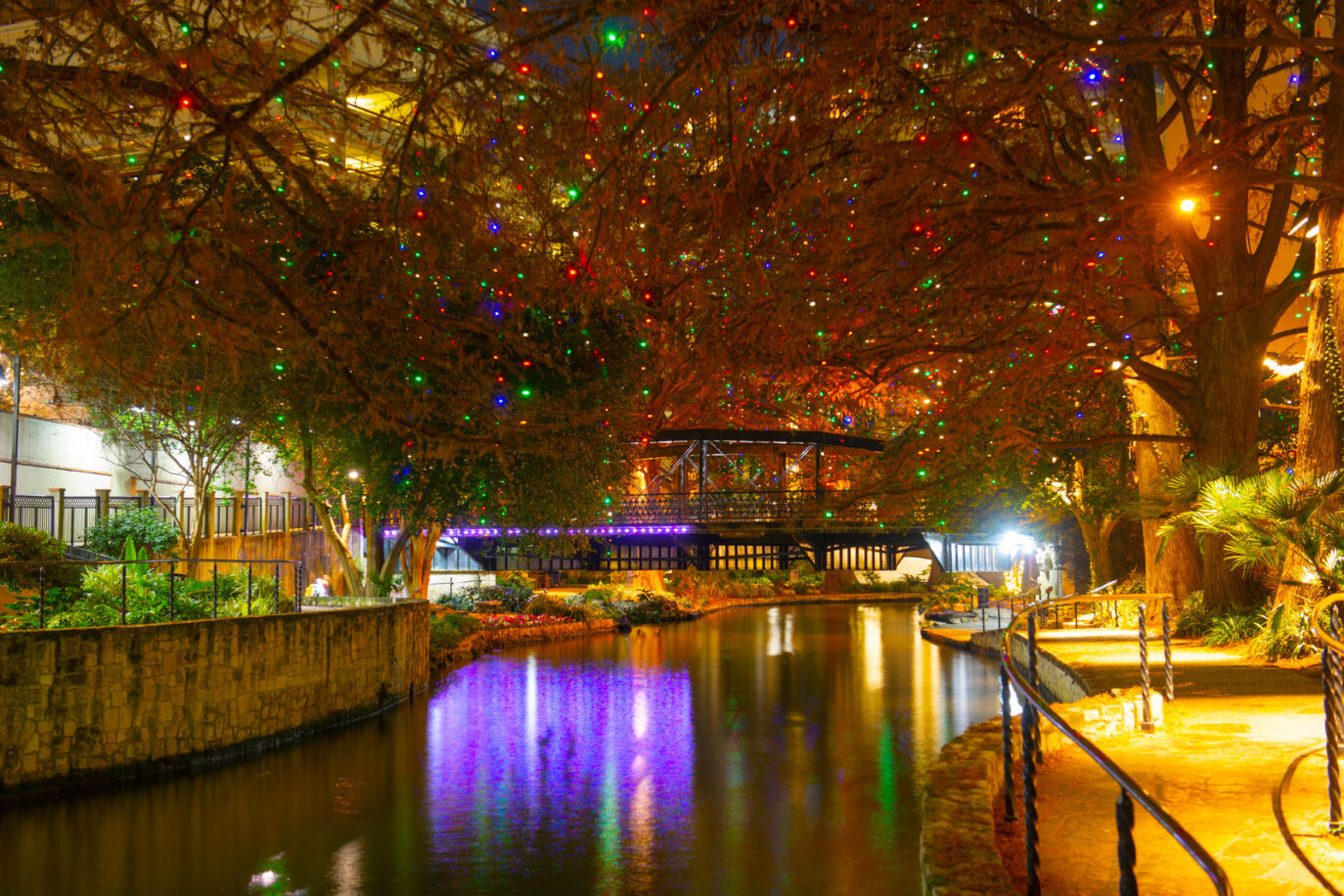 Lights hang from the trees over the San Antonio riverwalk